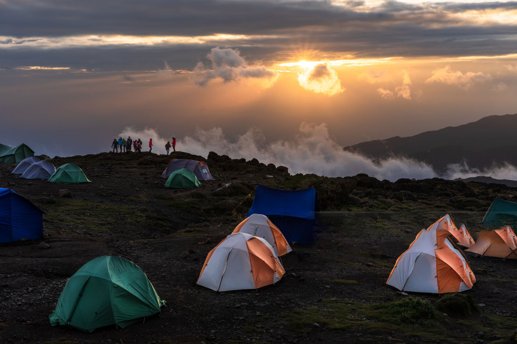 Tents of hikers attempting to climb Mount Kilimanjaro in Shira camp during sunset